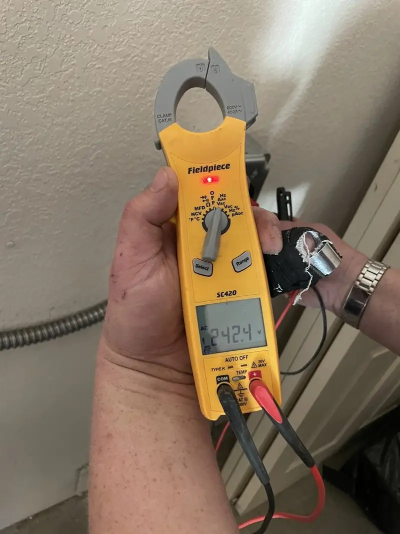Voltage testing with clamp meter during Whole House Surge Protector in Adel